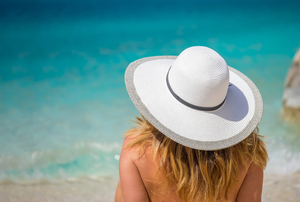 Young woman in white bikini looking at water - Photo, Image