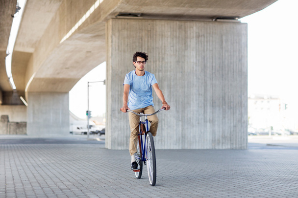 young hipster man riding fixed gear bike - 写真・画像