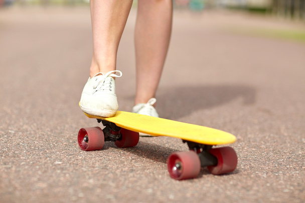 close up of female feet riding short skateboard - 写真・画像