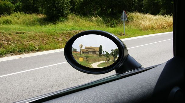 Фермерский дом отражается в зеркале заднего вида автомобиля
 - Фото, изображение