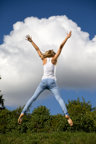 Young girl jumping in air - Fotó, kép