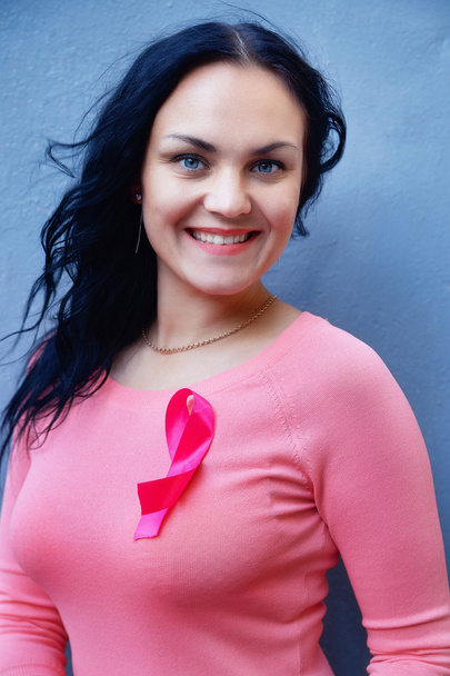 smiling young woman  with pink breast cancer awareness ribbon ov - Foto, Imagem
