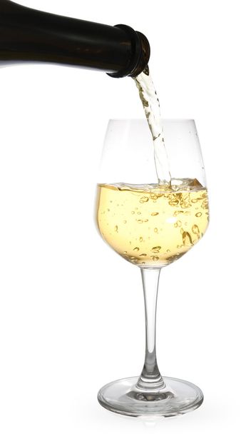 white wine pouring in a glass from a bottle - Zdjęcie, obraz