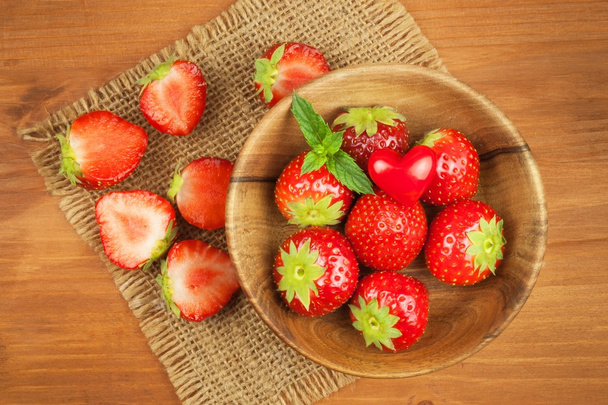 Strawberry on a wooden background. Advertising for the sale of fresh strawberries. - Photo, image