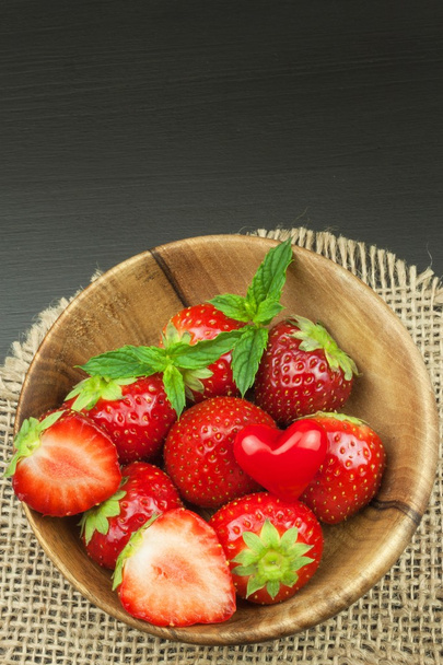 Strawberry on a wooden background. Advertising for the sale of fresh strawberries. - Photo, image