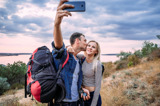 Young caucasian couple taking selfie - 写真・画像