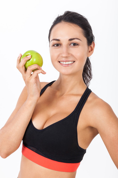 Close up of girl in sport bra with an apple - Фото, зображення
