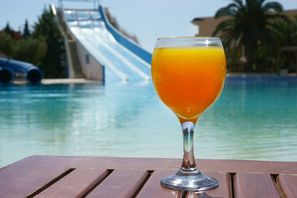 orange juice on a pool background - Zdjęcie, obraz