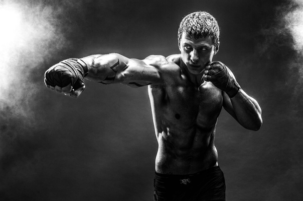 Handsome topless sportsman practicing punches - Foto, afbeelding