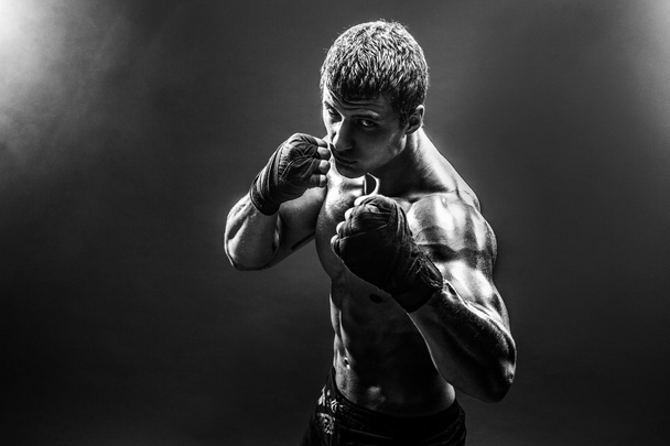 Handsome topless sportsman practicing punches - Fotó, kép