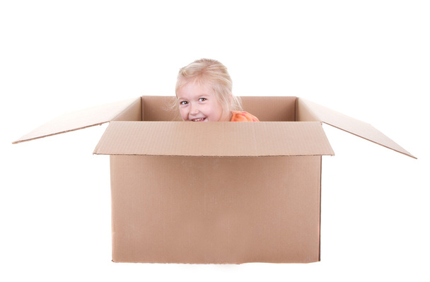 Child playing in a box - Фото, изображение