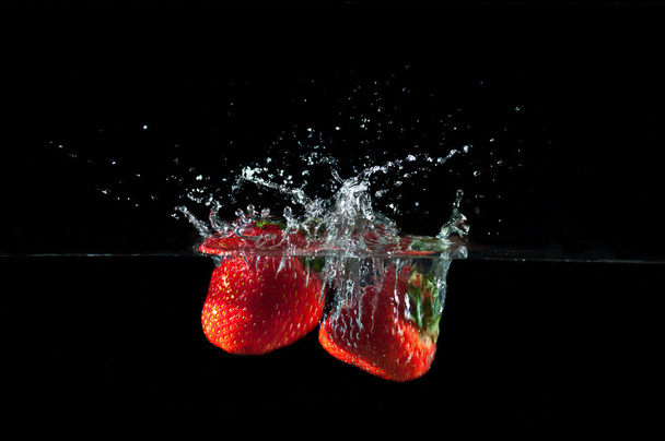 Strawberries splashing into water  - Valokuva, kuva