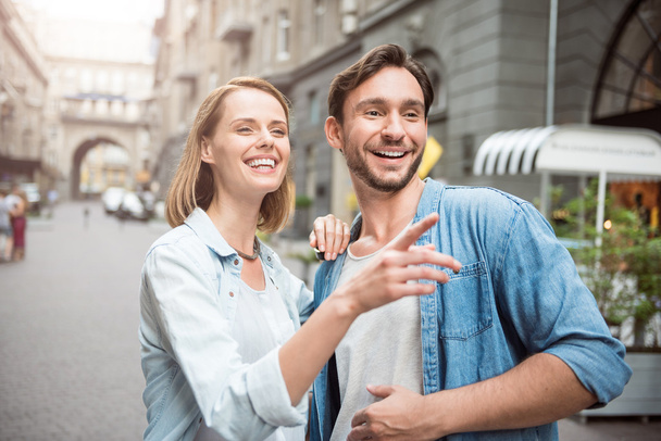 Positive loving couple standing in the street - Photo, Image