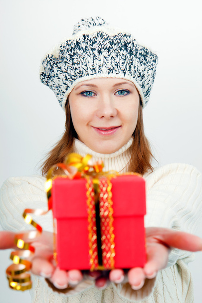 Attractive girl gives a wrapped gift - 写真・画像