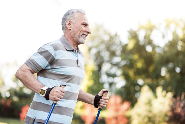 Handsome happy man in his 60s jogging - Foto, imagen