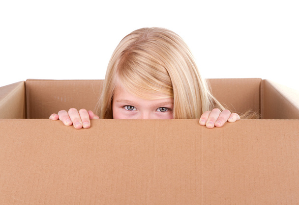 Child looking out of a box - Foto, afbeelding