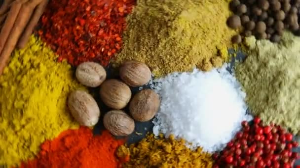 assortment of spices seasoning on a black stone - Footage, Video
