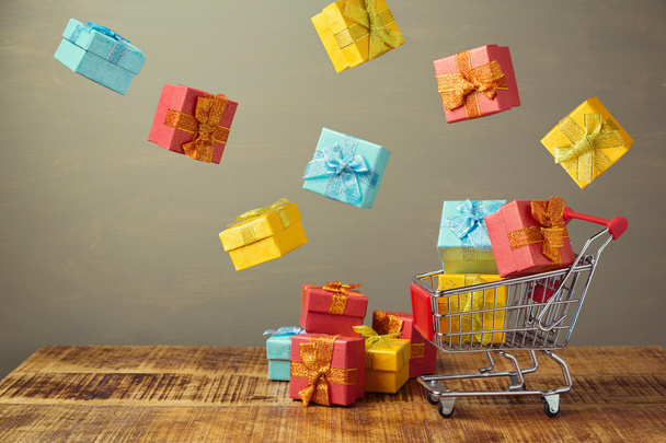 shopping cart and gift boxes  - Фото, зображення