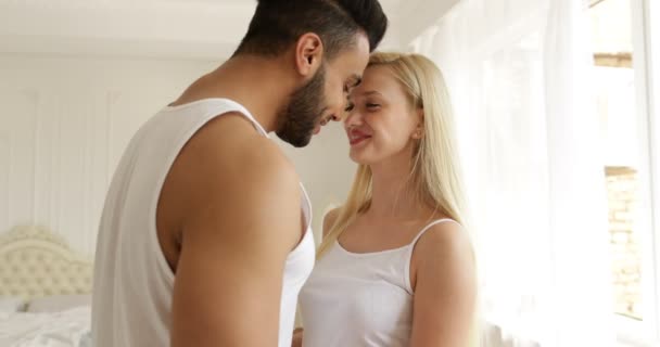 Couple love embrace smile standing face to face mix race man woman hug morning bedroom - Séquence, vidéo