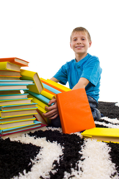 Boy holds pile of books - Foto, afbeelding