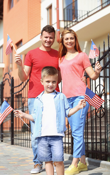 Happy family with American flags in the yard - Zdjęcie, obraz