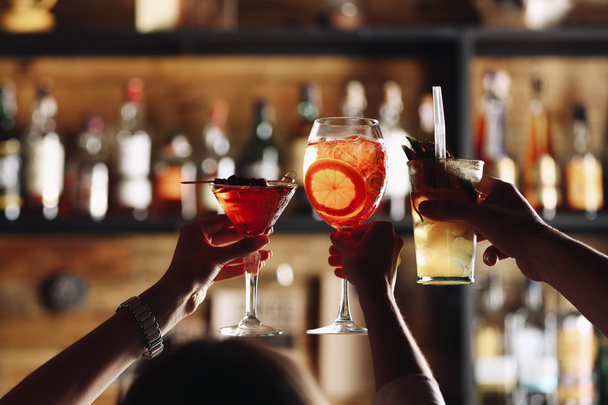 Friends toasting with cocktails in bar - Fotoğraf, Görsel