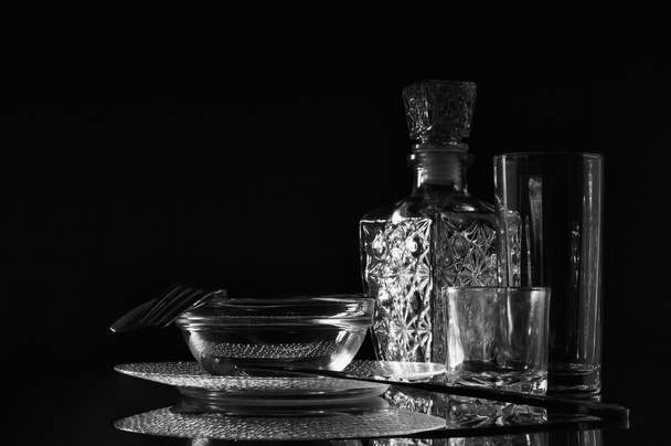 Glass and metal cutlery, glare on a dark background. - Fotó, kép