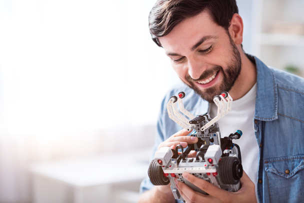 Joyful man holding robot - Фото, зображення