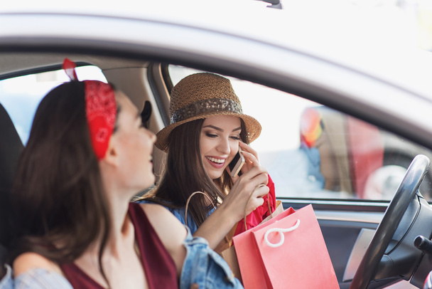 friends in a vehicle with bags after shopping - Foto, Imagem