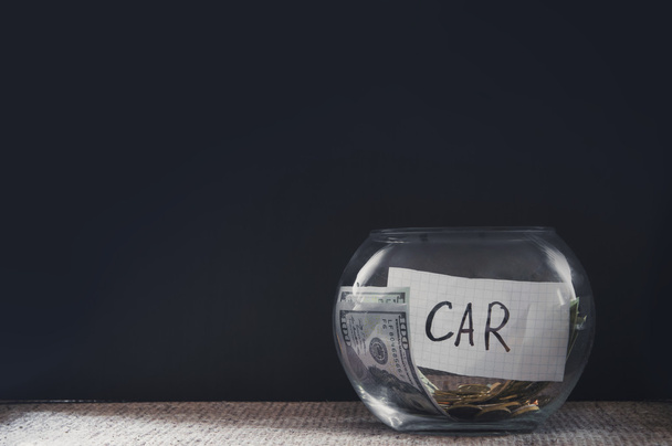 Glass jar with coins for car - Foto, imagen