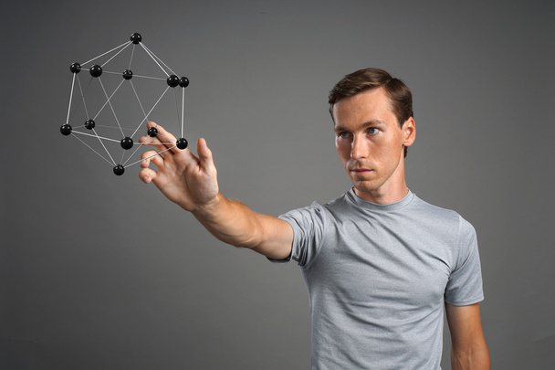 Man scientist working with model of molecule or crystal lattice. - Photo, Image