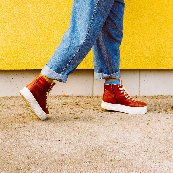 Step in Fall. Stylish red sneakers. Urban fashion - Φωτογραφία, εικόνα