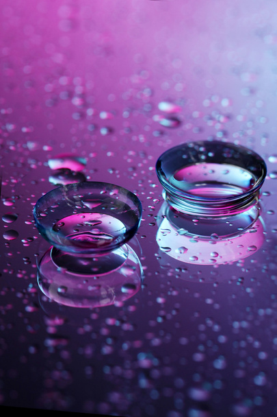 Contact lenses, on pink-blue background - Foto, afbeelding