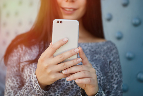 Girl taking photo with modern dual camera smart phone - Foto, Imagen