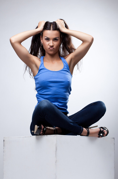 Sexy brunette sit in jeans and blue tank top - Foto, Imagem
