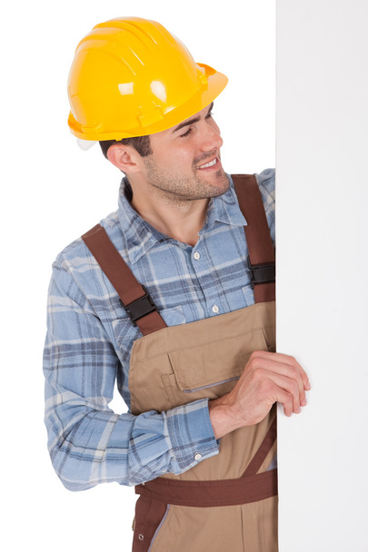 Worker wearing hard hat and holding empty banner - Photo, image