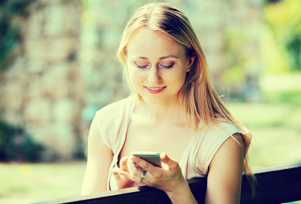 Woman texting using mobile phone - Фото, зображення