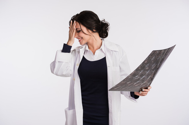 Beautiful female doctor nurse holding x-ray tired - Photo, image