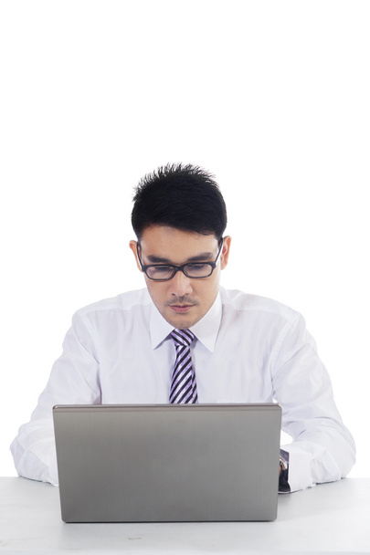 Male employee working seriously with laptop - Φωτογραφία, εικόνα