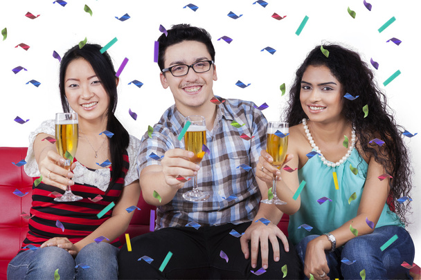 Three multiracial people holding champagne - Fotoğraf, Görsel