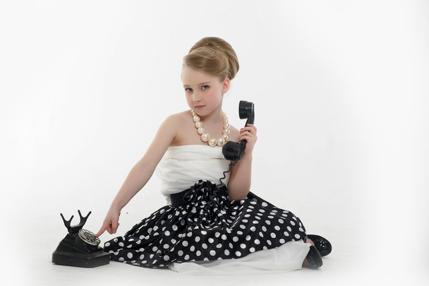 Little girl with a retro phone - Fotó, kép