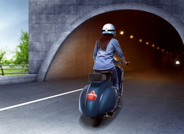 woman on scooter entering tunnel - Foto, afbeelding