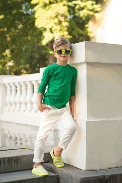 Trendy boy in sunglasses . He is very stylishly dressed .  - Photo, Image