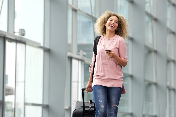Female traveler holding cellphone - Fotó, kép