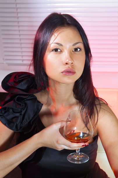 Woman with glass of cognac - 写真・画像
