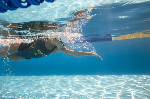 Woman swims underwater - Фото, изображение