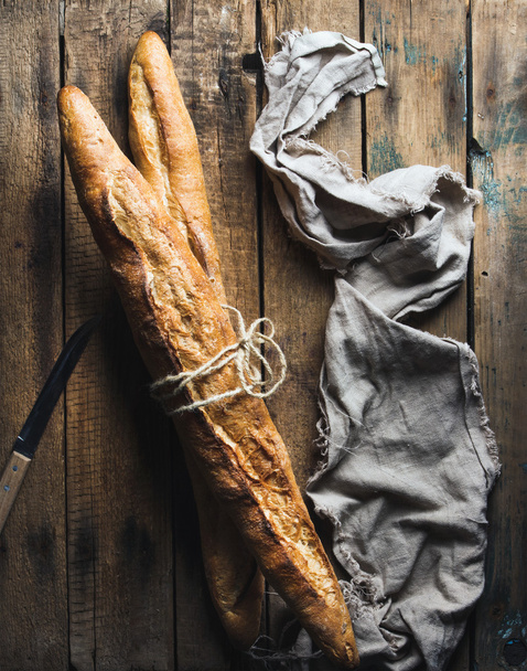 French baguettes on wooden background - Fotoğraf, Görsel