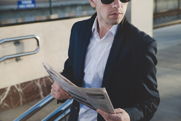 Businessman talking on the phone and holding a newspaper. - Φωτογραφία, εικόνα