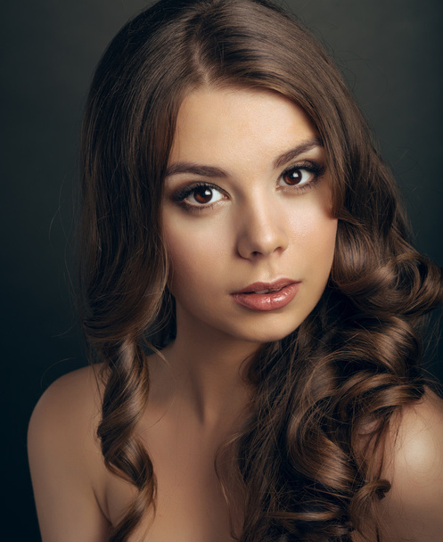 Portrait of a young beautiful brunette girl with long  hair - Fotó, kép