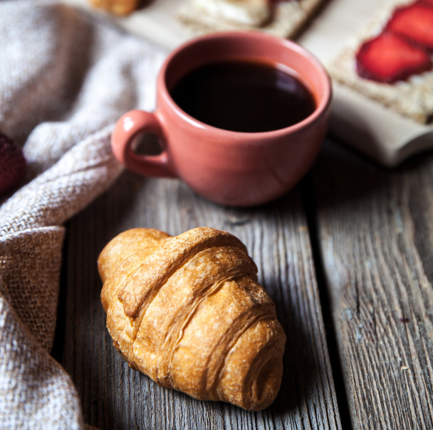 delicious breakfast with a cup of coffee and fruit sandwiches, croissants. Strawberries, food, drink, chocolate. - Foto, imagen